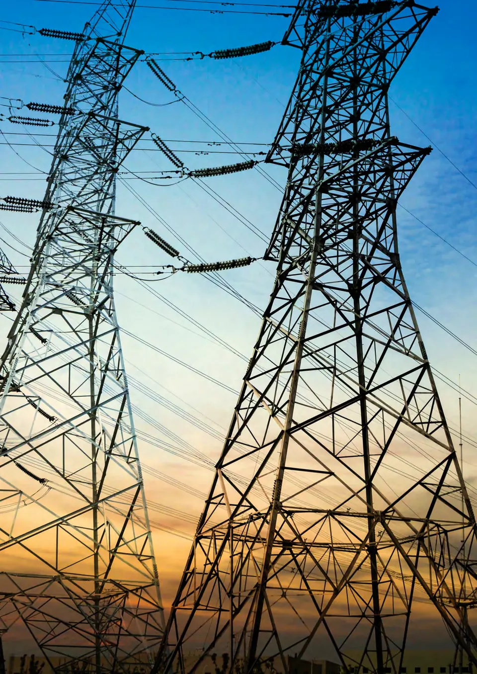 Transmission towers and conductors against an evening sky